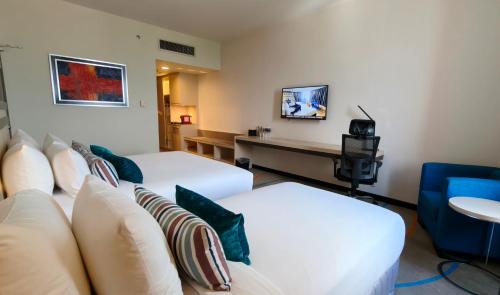 a hotel room with two beds and a couch at Premiere Hotel - Complimentary Shuttle to Klang Wholesale Market in Klang