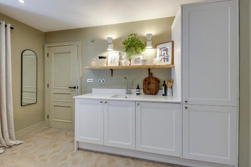 a white bathroom with a sink and a mirror at Apartments for two in Brand New Luxury Rural Farmhouse Escape in Ramsbottom