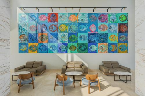 a room with chairs and tables and a large painting on the wall at Blue Lagoon Queen in Kalyves Poligirou