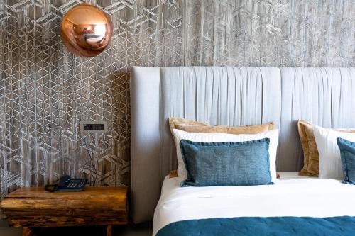 a bedroom with two beds and a headboard and a table at Bavaro Beach Dakhla in Dakhla