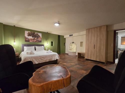 a hotel room with a bed and a coffee table at Αρχοντικό Ορεάδες ΙΙΙ in Nafpaktos