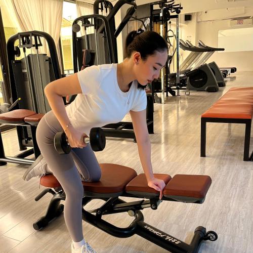 a woman is sitting on a chair in a gym at 88th Avenue in Cebu City