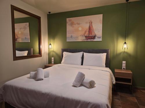 a bedroom with a large bed with towels on it at Αρχοντικό Ορεάδες ΙΙΙ in Nafpaktos
