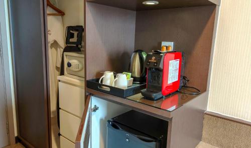 a kitchen with a counter with a coffee maker on it at Premiere Hotel - Complimentary Shuttle to Klang Wholesale Market in Klang