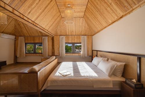a bedroom with a large bed and a couch at 22 Garden House in Jinghong