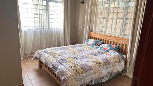 a bedroom with a bed and a window at kijiji Nest in Usa River