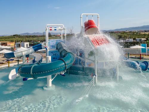 a water park with a water slide in the water at Blue Lagoon Queen in Kalyves Poligirou