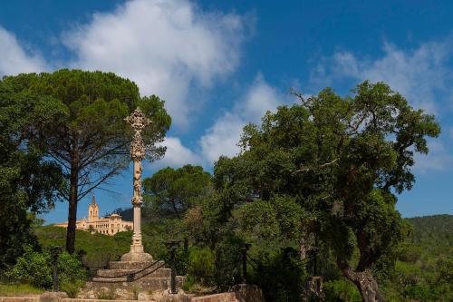 a statue in a park with a building in the background at Sant Pere del Bosc Hotel & Spa - Adults Recommended in Lloret de Mar