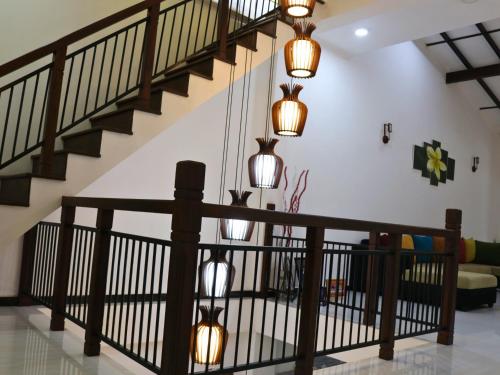 a living room with a staircase with lights at Aqua Breeze Villa in Ja-Ela
