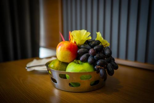 a bowl of fruit sitting on a table at West Bay MARISOL in Varkala