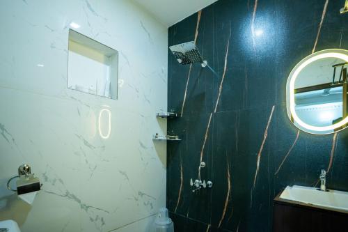 a bathroom with a sink and a mirror at West Bay MARISOL in Varkala