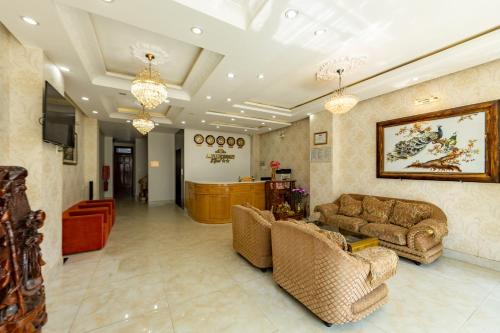 a living room with two couches and a tv at AM Memory Central Hotel 2 in Da Lat