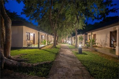 a walkway in front of a building at night at Kassapa Lions Rock in Sigiriya