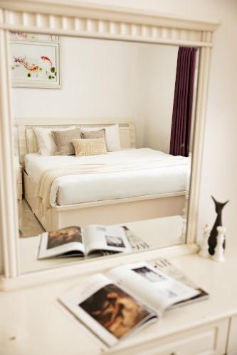 a mirror reflection of a bedroom with a bed at AM Memory Central Hotel 2 in Da Lat