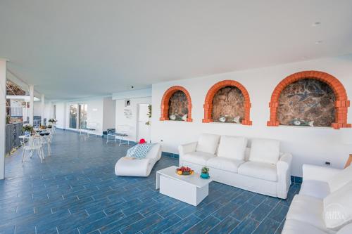 a living room with white couches and a table at Villa Blue Sea Amalfi by Elite Villas in Ravello