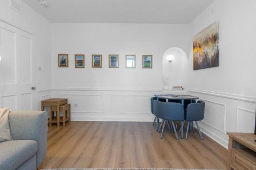 a living room with a couch and a table at Luxury Central Hidden Gem in Musselburgh