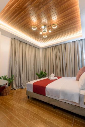 a bedroom with a bed in a room with curtains at Loboc Riverside Inn & Restaurant in Loboc