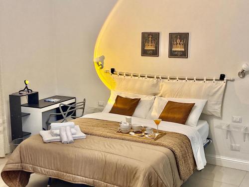 a bedroom with a large bed with a yellow headboard at Casa Frori - Unique Experience in Sassari