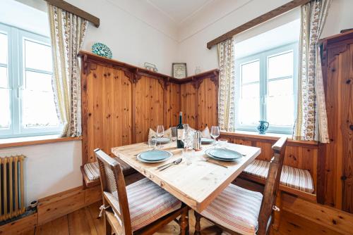 a dining room with a wooden table and chairs at SIEGLGUT in Altaussee