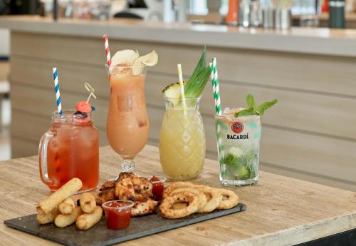 a table with some drinks and pretzels and pretzels at B&B HOTEL près de Disneyland Paris in Magny-le-Hongre