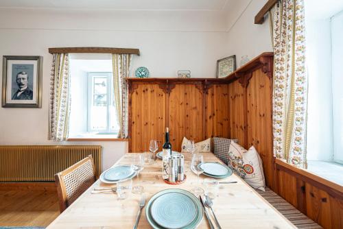 a dining room with a table with plates on it at SIEGLGUT in Altaussee