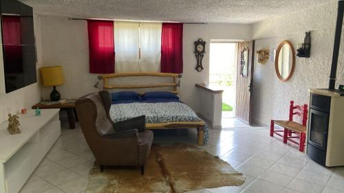 a bedroom with a bed and a chair and a television at Residence Ai Laghi in Temossi