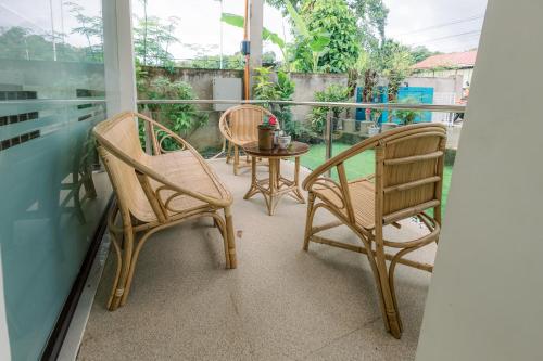 two chairs and a table on a balcony at Loboc Riverside Inn & Restaurant in Loboc