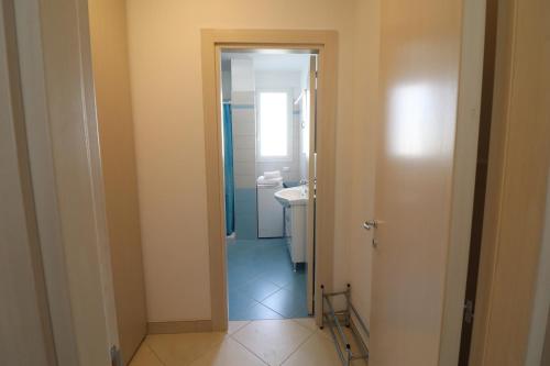 a bathroom with a toilet and a sink at Casa Francesca Otranto Modern 3 Guest Flat with AC & WiFi in Otranto