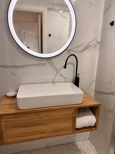 a bathroom with a white sink and a mirror at Garden sea view - Victoria - Le Cannet in Le Cannet