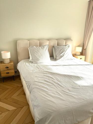 a large white bed with two pillows on it at Garden sea view - Victoria - Le Cannet in Le Cannet