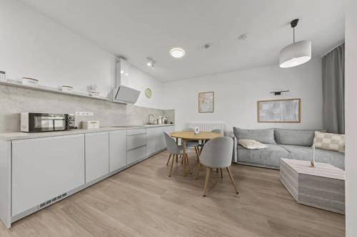 a kitchen and living room with a table and a couch at Panorama View II in Veľký Slavkov