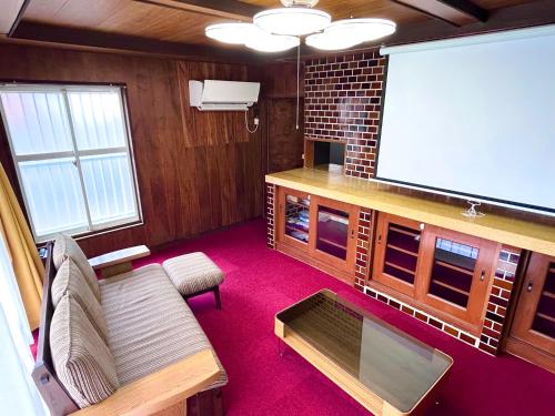 a living room with a large projection screen at ポートサイドSasebo泉町 in Sasebo
