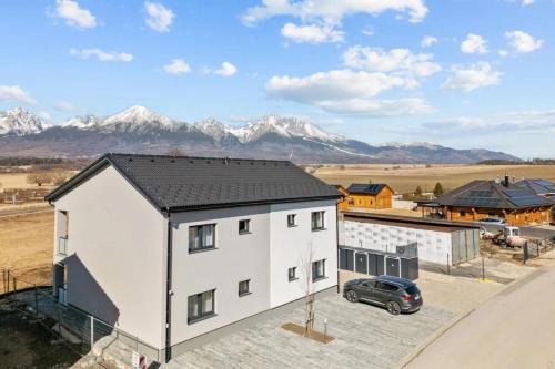 an aerial view of a white house with mountains in the background at Panorama View II in Veľký Slavkov