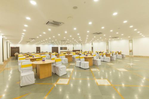 a large room with tables and chairs in it at The Metropole by Keyboard Hotels in Lonavala