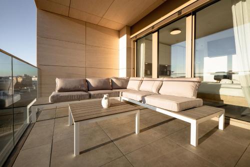 a living room with a couch and a table at Modern Studio in Gasperich with Balcony & Wi-Fi in Luxembourg