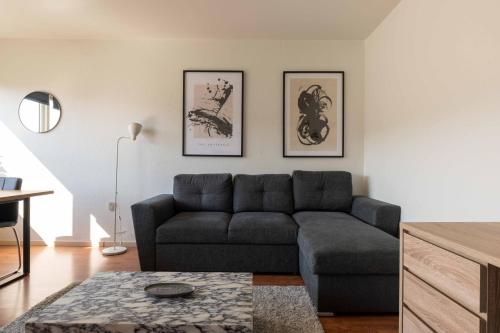 a living room with a couch and a table at Cozy Apartment Near Metro in Copenhagen