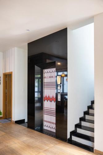 a hallway with a stairway leading to a room at Boho Boutique Da Lat - View nhà lồng lãng mạn in Da Thanh