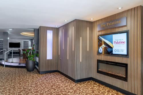 a lobby with a fireplace and a flat screen tv at Airport Hotel Manchester in Manchester