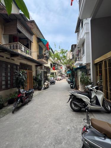 a group of motorcycles parked on a street next to buildings at Studio 2 Byhomelinh Phố Cổ Hoàn Kiếm in Hanoi