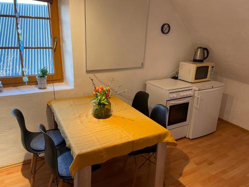 a room with a table with chairs and a microwave at Wolfshof in Welling