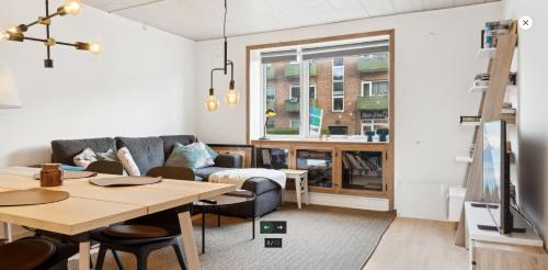 a living room with a table and a couch at Close to city center in Rødovre