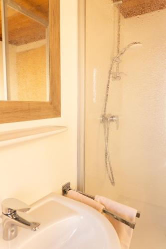 a bathroom with a sink and a shower at Pension Trillerhof in Ramsau am Dachstein
