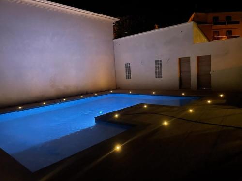 - une piscine éclairée sur le côté du bâtiment dans l'établissement Maison d'exception au Cap Corse, à Luri
