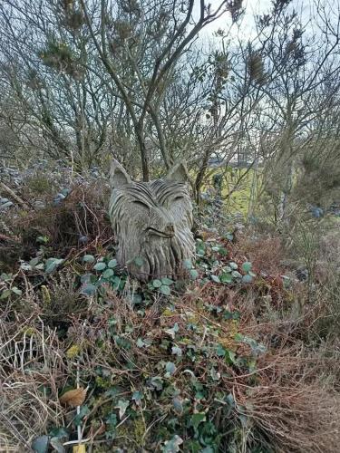 a statue of a zebra laying in the grass at Gîte de Rosvern in Commana