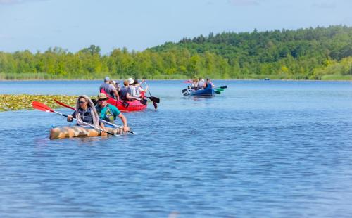a group of people in kayaks on a lake at Hostel Waldhaus am Ferienpark Gruppenhaus in Mirow