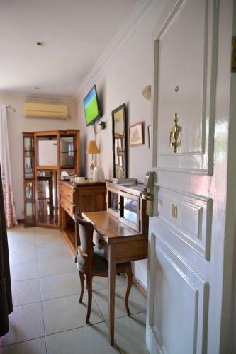 a home office with a desk and a table at Hotel Brajas in Antananarivo