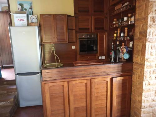 a kitchen with wooden cabinets and a refrigerator at 4BR by the Sea, Family friendly, Breathtaking View in Avia