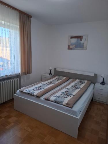a bedroom with a bed in a room with a window at Ferienhaus Magnolie in Eschwege