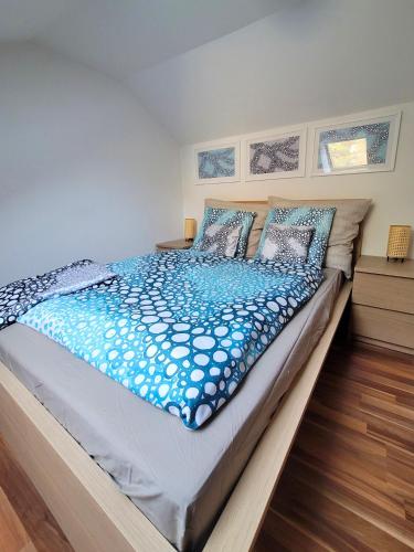 a bedroom with a large bed with blue sheets and pillows at ShalalaLiving Apartments Mariazell in Mariazell