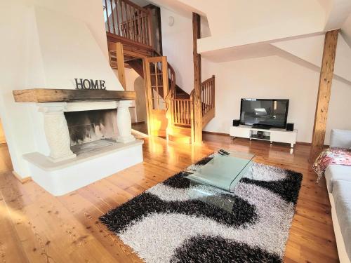 a living room with a fireplace and a tv at ShalalaLiving Apartments Mariazell in Mariazell